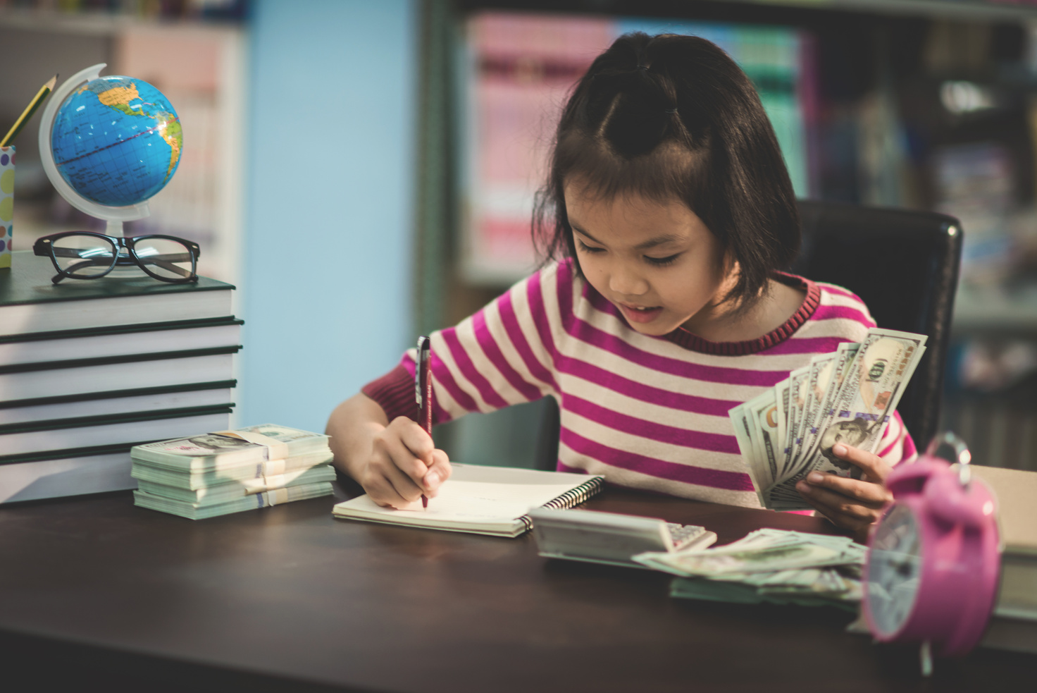 Portrait of a Student Child Girl Studying with Money,Mathematics
