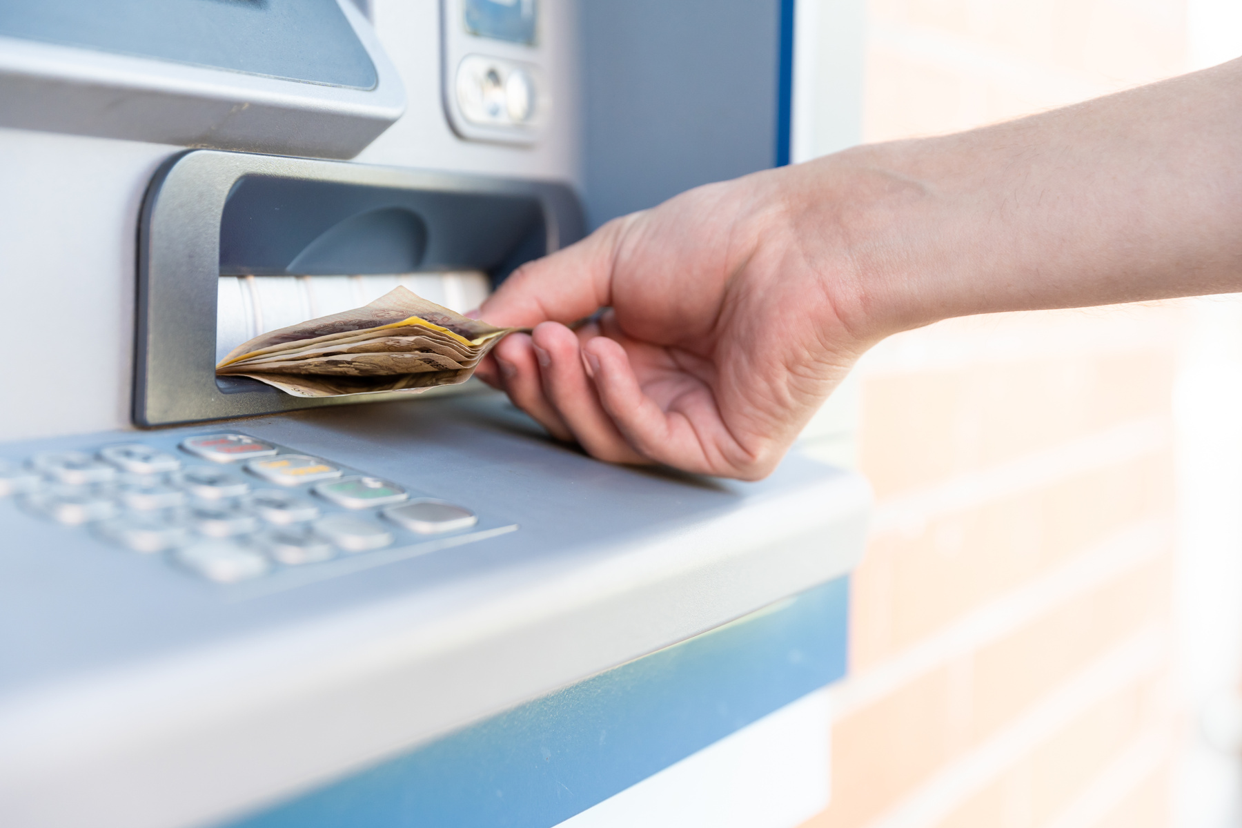 Person Withdrawing Cash from ATM 