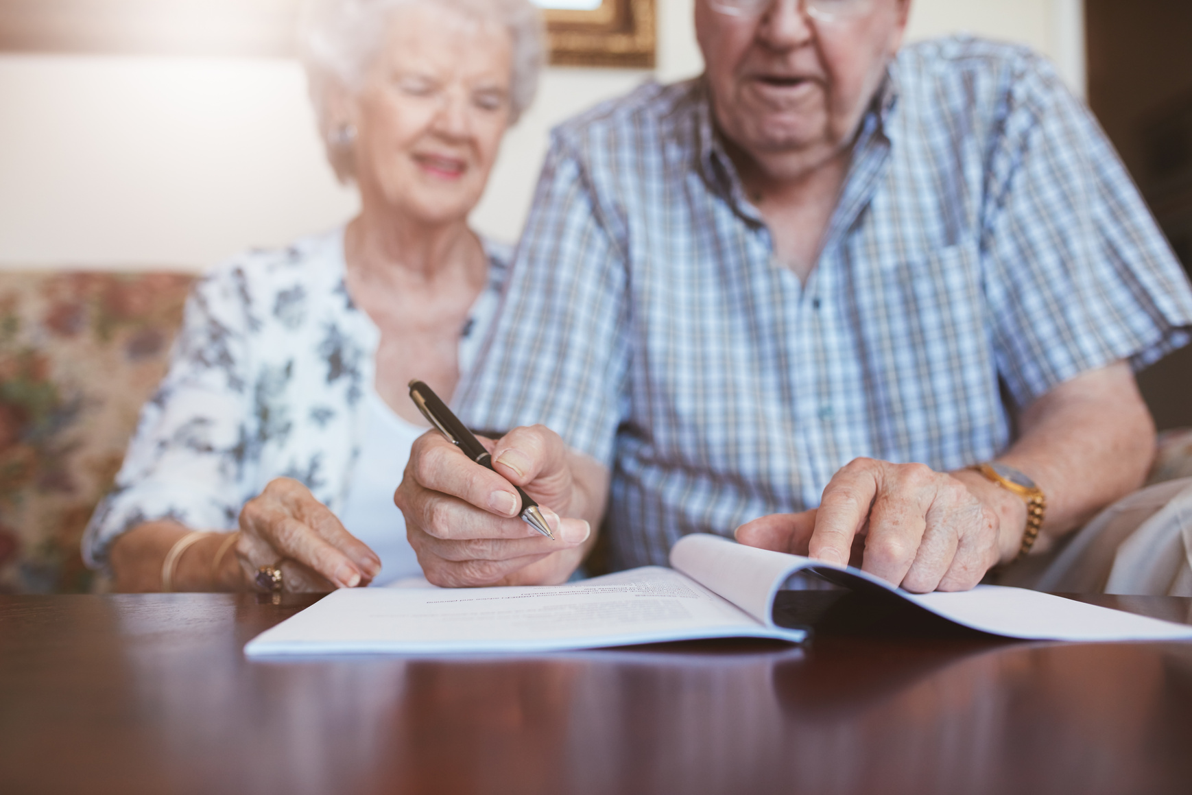 Senior Couple Signing Their Will Documents